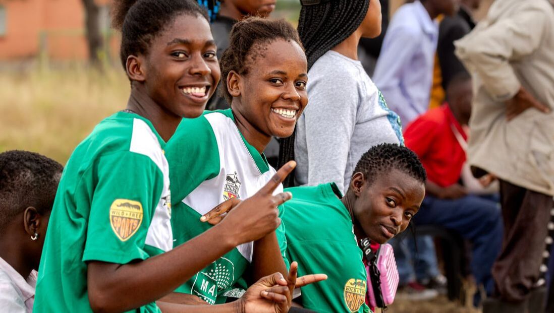 This photograph captures a moment of joy for three young female football players that are part of the RCCL Mozambique Girl’s League. The female football club is called Judeus FC Crocodiles and it is sponsored by a private group of family and friends organized by Denise Maxwell. As a result, the sponsor name displayed on the shirts is MAXWELL.