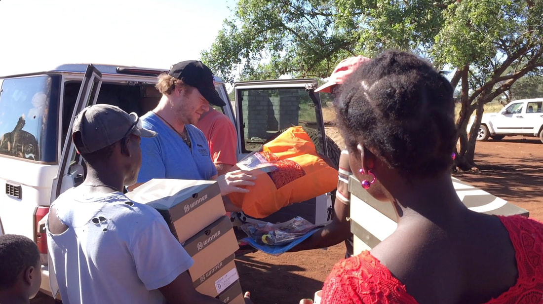 Matt Bracken deliver soccer equipment to the soccer team of Mucacaza in Mozambique. An image from the 2017 Rhino Cup season.