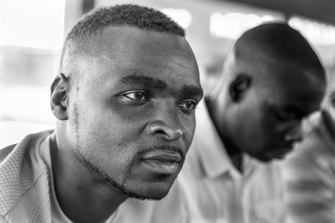 In this photo is Orlando “Watch” Cossa, a committee member of the Rhino Cup Champions League, Sàbié, Mozambique. Photo taken in the afternoon at a meeting during the 2019 RCCL season. Image taken at a local restaurant known as “Banana Landia”.