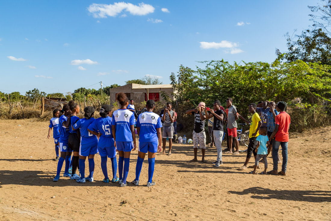 The female soccer team, Peregrinas de Sabie F.C., posed for a fan photo just before the very first kick-off of the Women's Rhino Cup Champions League 2019, Sabié, Mozambique. Peregrinas de Sabie is sponsored by Travel Beyond (a travel agency in Wayzata, Minnesota).