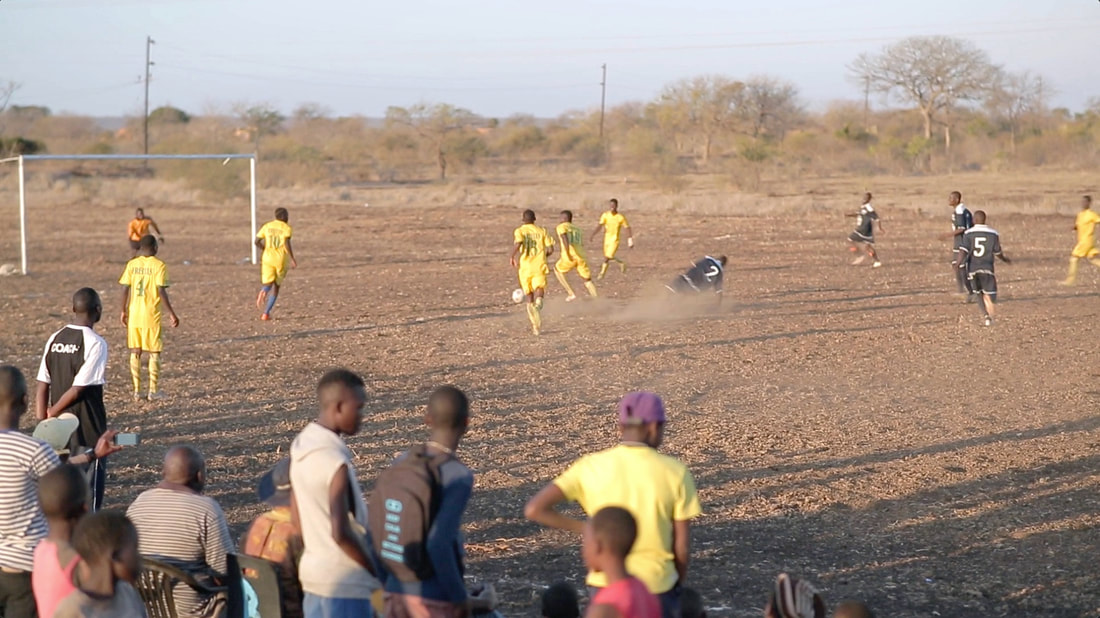 Club de Corumana (blue kit) vs. Freitas FC (yellow kit), August 27, 2016, on the sandy gravel surface of Corumana soccer field. Wild and Free Foundation's goal is to create a community-wide conservation initiative from the ground up.